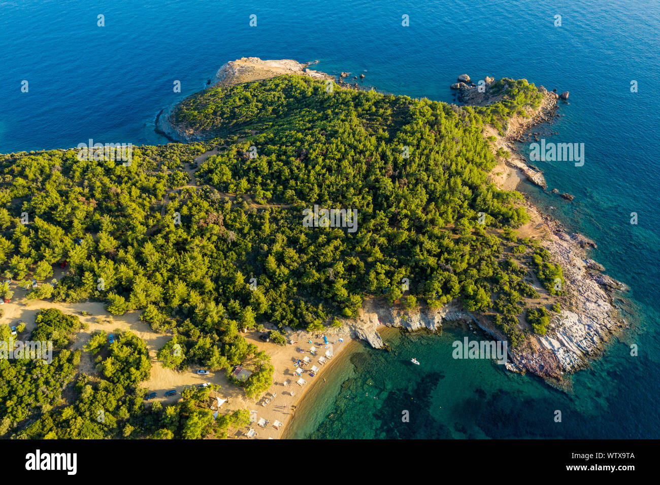 Aerial drone view of beach umbrellas and sunbeds on the coast in Thassos  island, Greece Stock Photo - Alamy