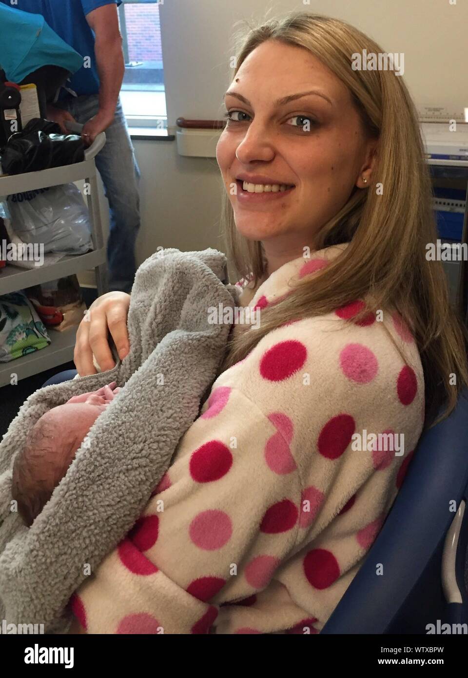 Side View Portrait Of Smiling Mother With Newborn Baby Boy On