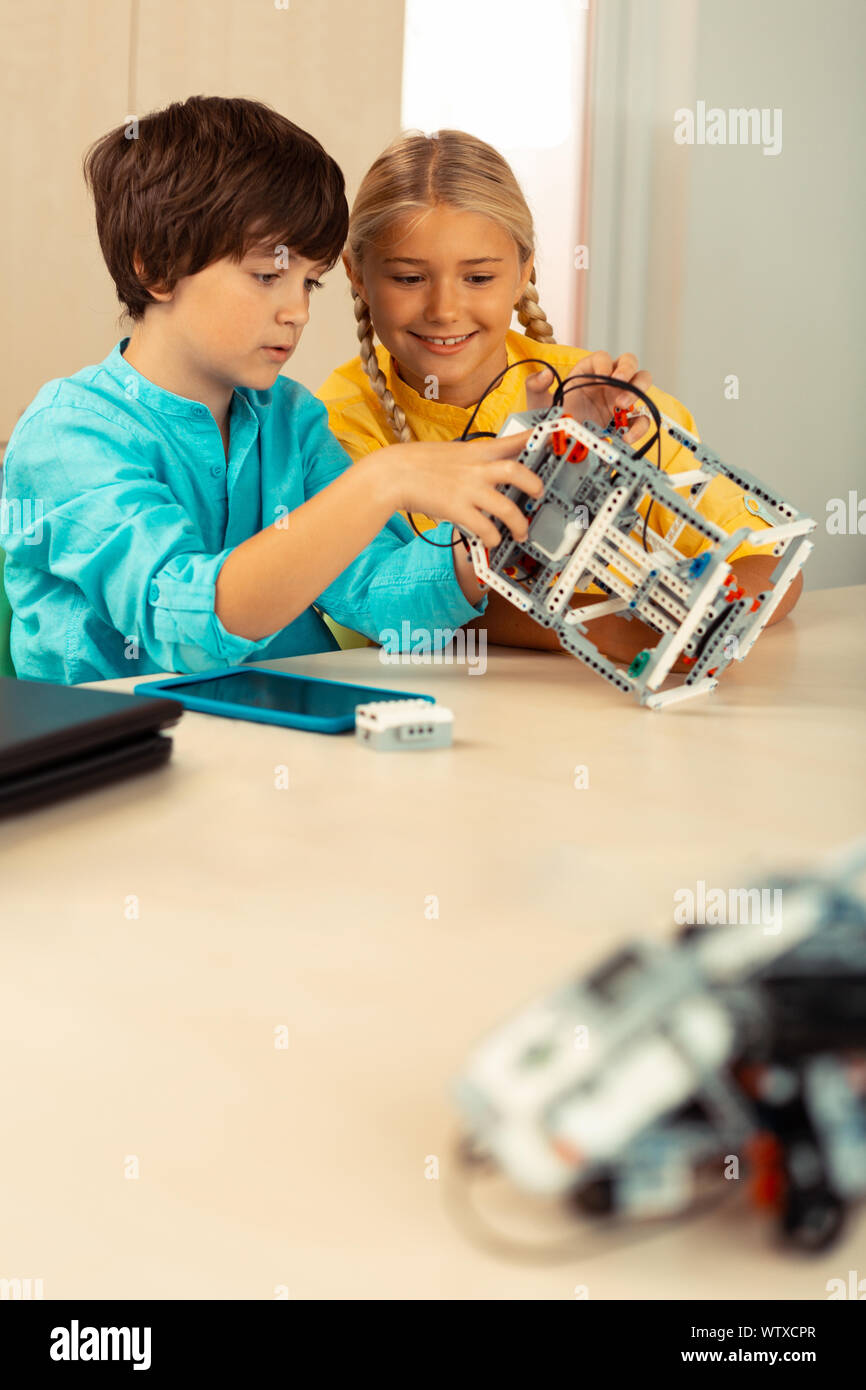 Two schoolchildren building a robot at science class Stock Photo - Alamy