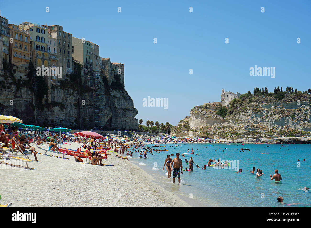 Public beach in Tropea, Calabria, Italy. View from North in August 2019, with the hill with the Church of Santa Maria from Island, at the back Stock Photo