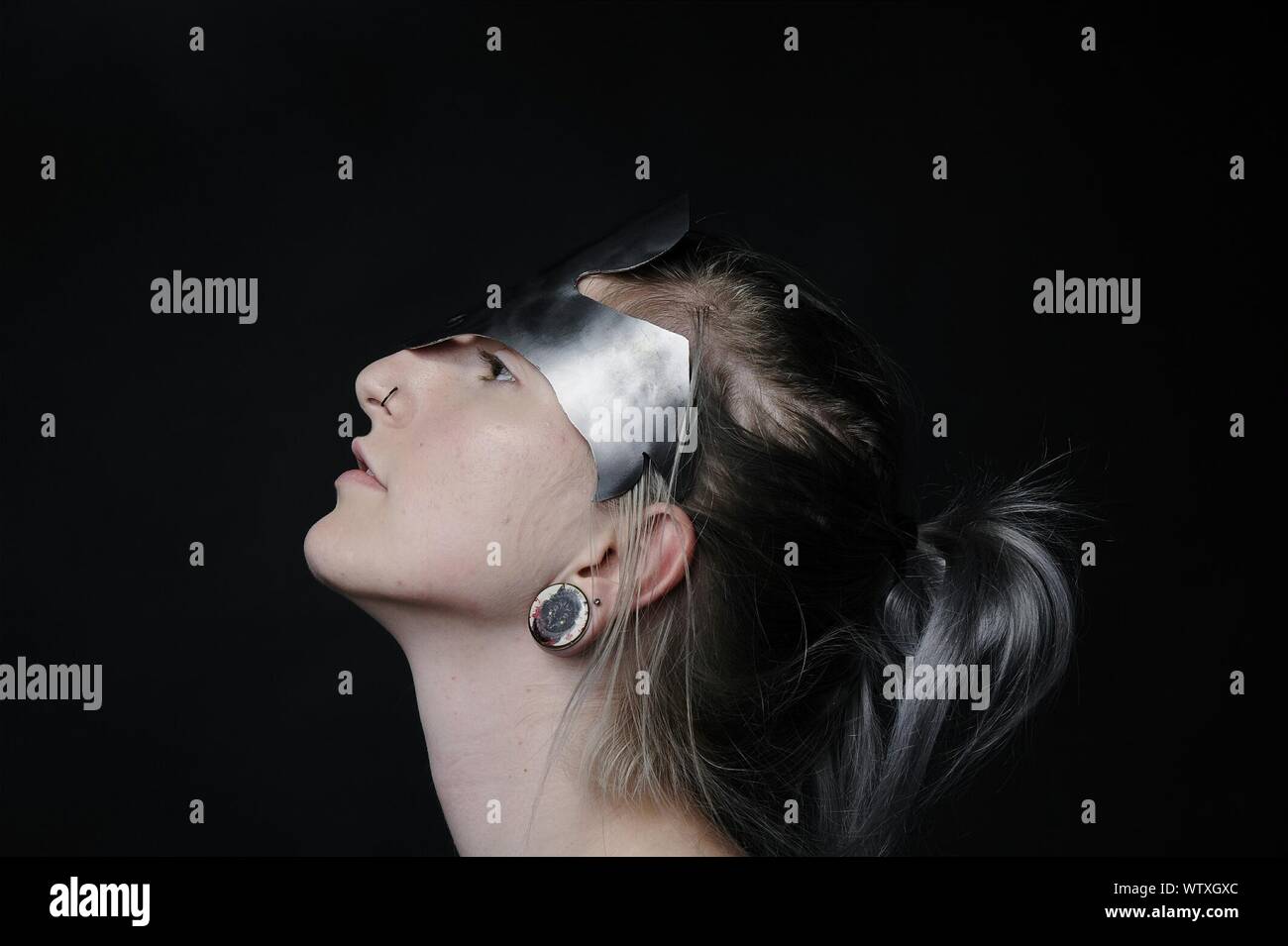Profile View Of Young Woman Wearing Headdress Against Black Background Stock Photo