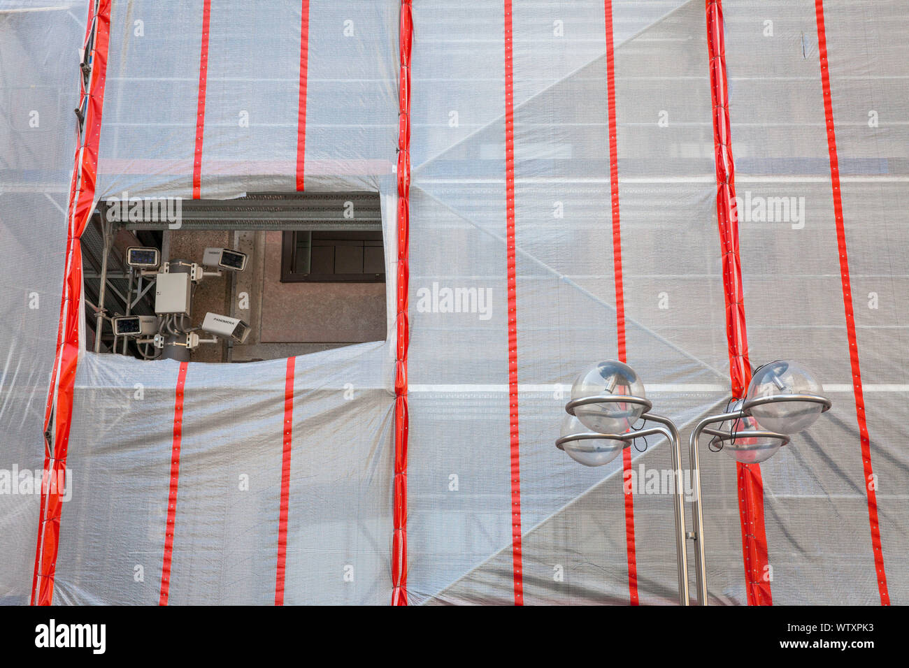 surveillance cameras on the square in front of the cathedral, cutout in scaffolding tarpaulin at the Domforum building, Cologne, Germany.   Ueberwachu Stock Photo