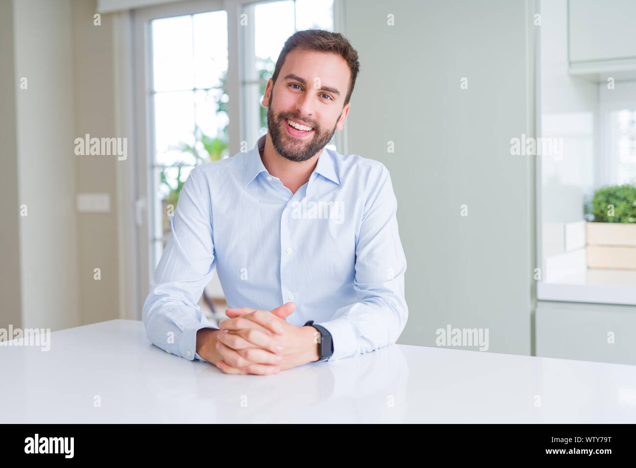 Handsome business man smiling positive at the camera Stock Photo - Alamy