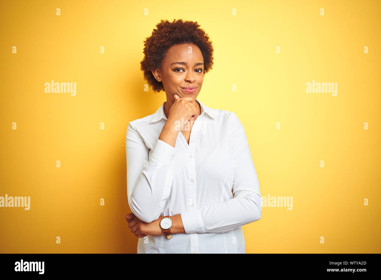 African american business woman over isolated yellow background looking ...