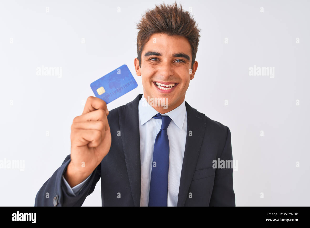 Young handsome businessman wearing suit holding credit card over ...