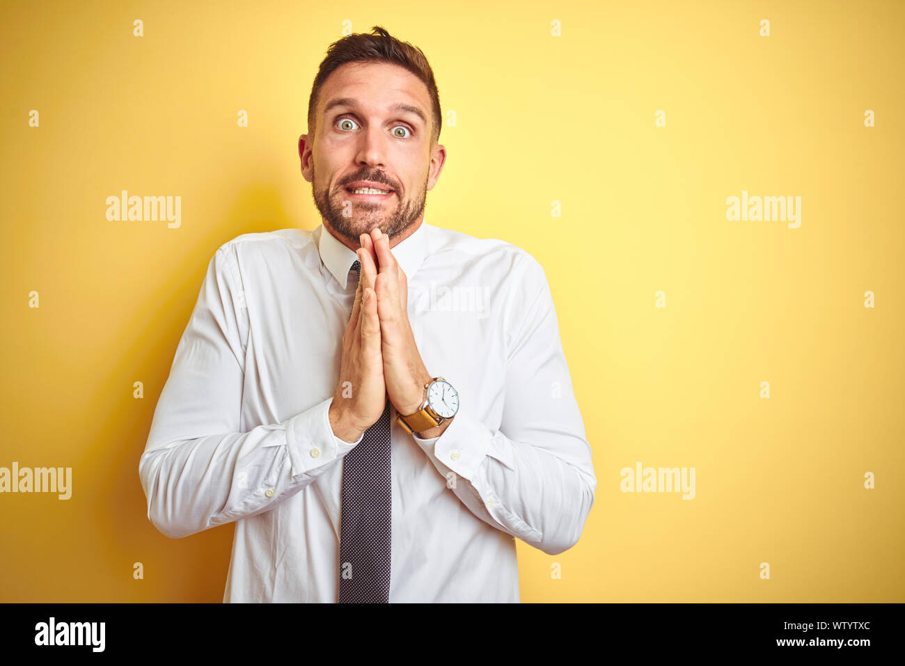 Forgiven Man Young handsome business man wearing elegant white shirt over yellow ...