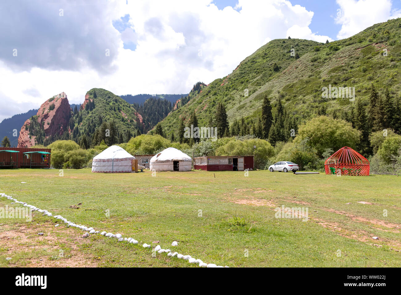 Rock Broken Heart in the Jeti-Oguz gorge Kyrgyzstan with white yurts in the foreground Stock Photo