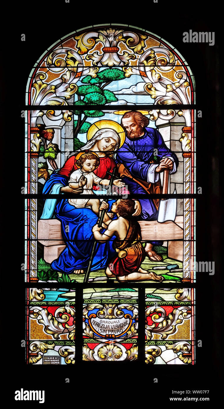 Holy Family with St. John the Baptist, stained glass window in the Saint John the Baptist church in Zagreb, Croatia Stock Photo