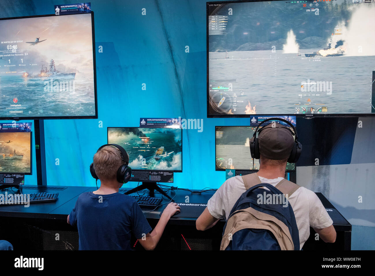 visitors play the game „World of Warships“ at gamescom , world's