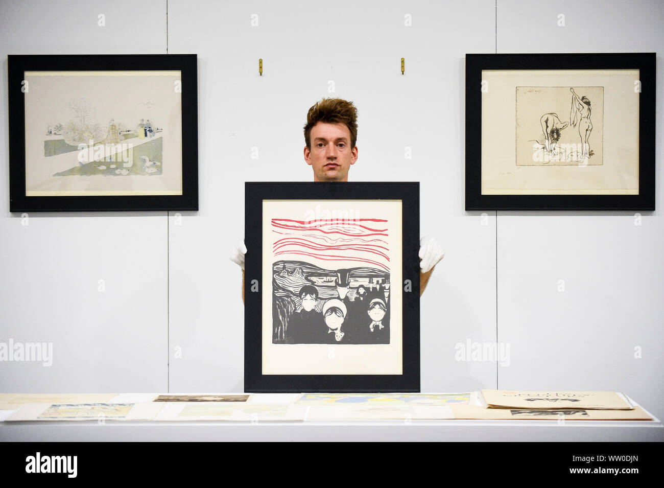 London, UK.  12 September 2019.  A technician presents a lithograph 'Le Soir' (Angst) by Edvard Munch at a photocall for 'Les Peintres-Graveurs', a multi-artist portfolio of lithographs published in 1896 by Ambroise Vollard, to be auctioned at Sotheby's on September 17 with an estimate of £500,000 to £1,000,000.  It is the only known complete example and includes 22 prints by the greatest Impressionist and Post-Impressionist artists., as well as the first colour lithograph by, a then not so well-known, Edvard Munch. Credit: Stephen Chung / Alamy Live News Stock Photo