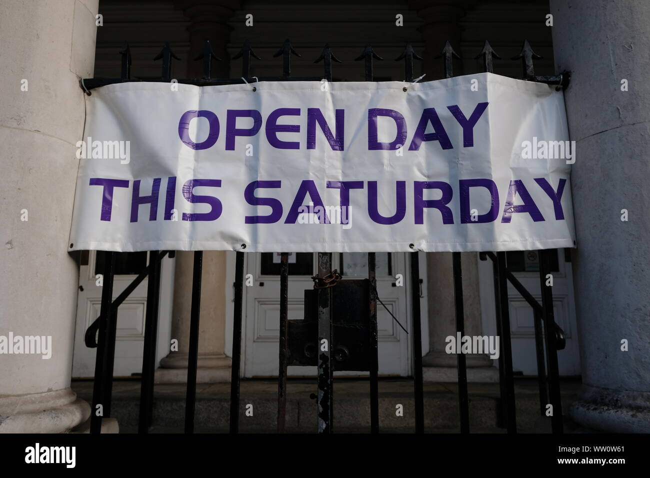 Open day this saturday Banner hanging on gate of a public building Stock Photo