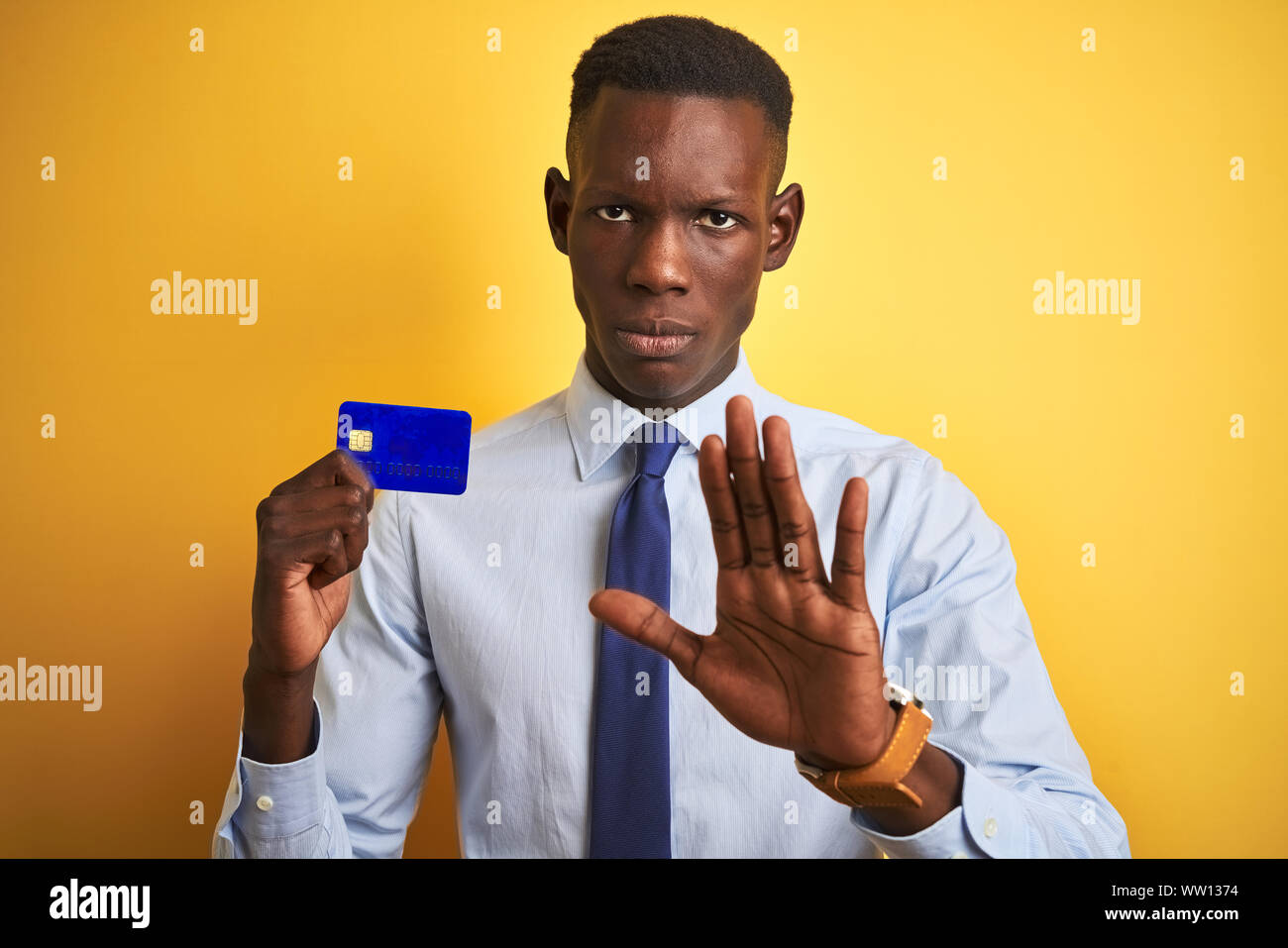 African american businessman holding credit card standing over isolated ...