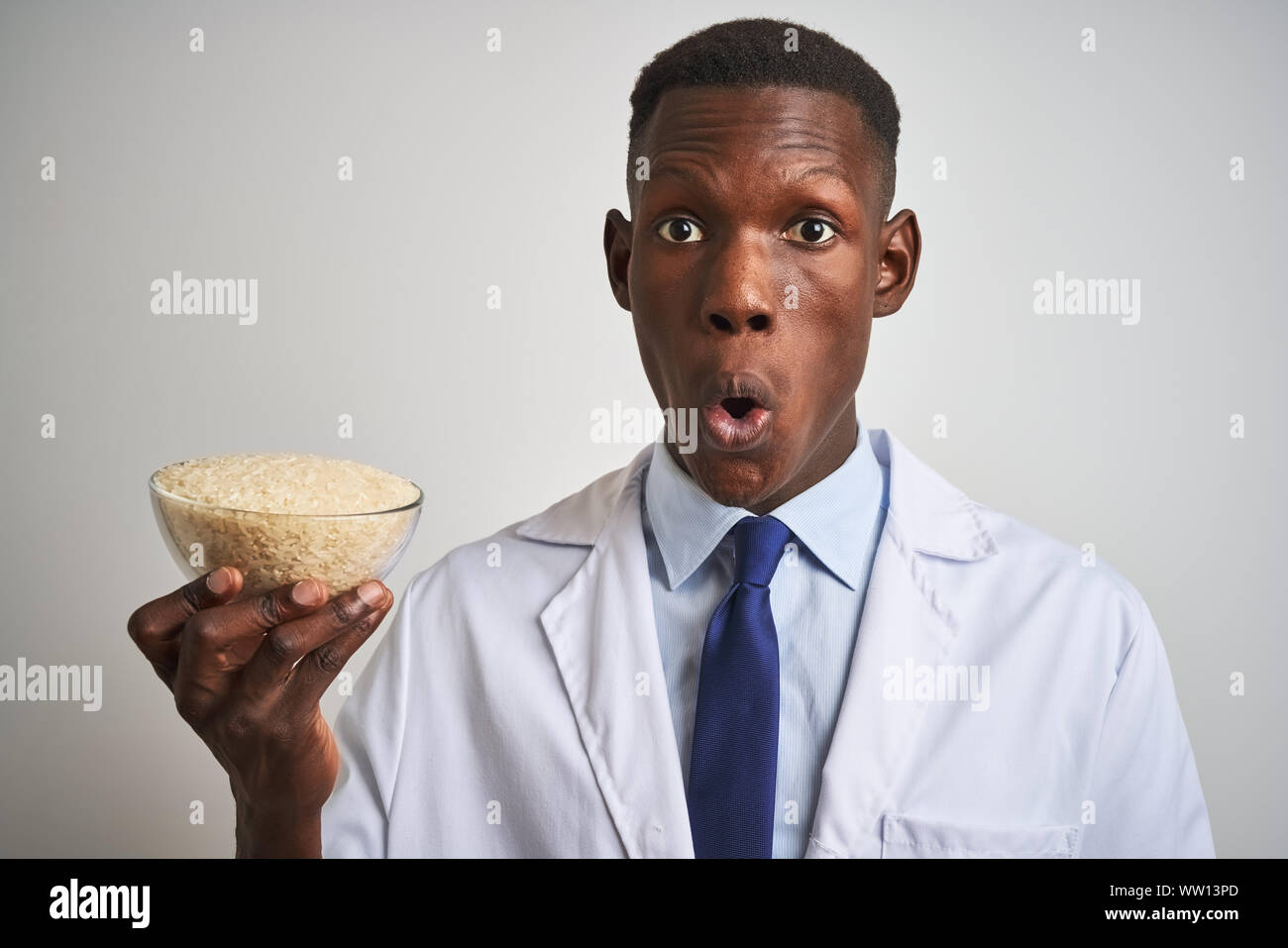 African american doctor man holding bowl with rice standing over ...