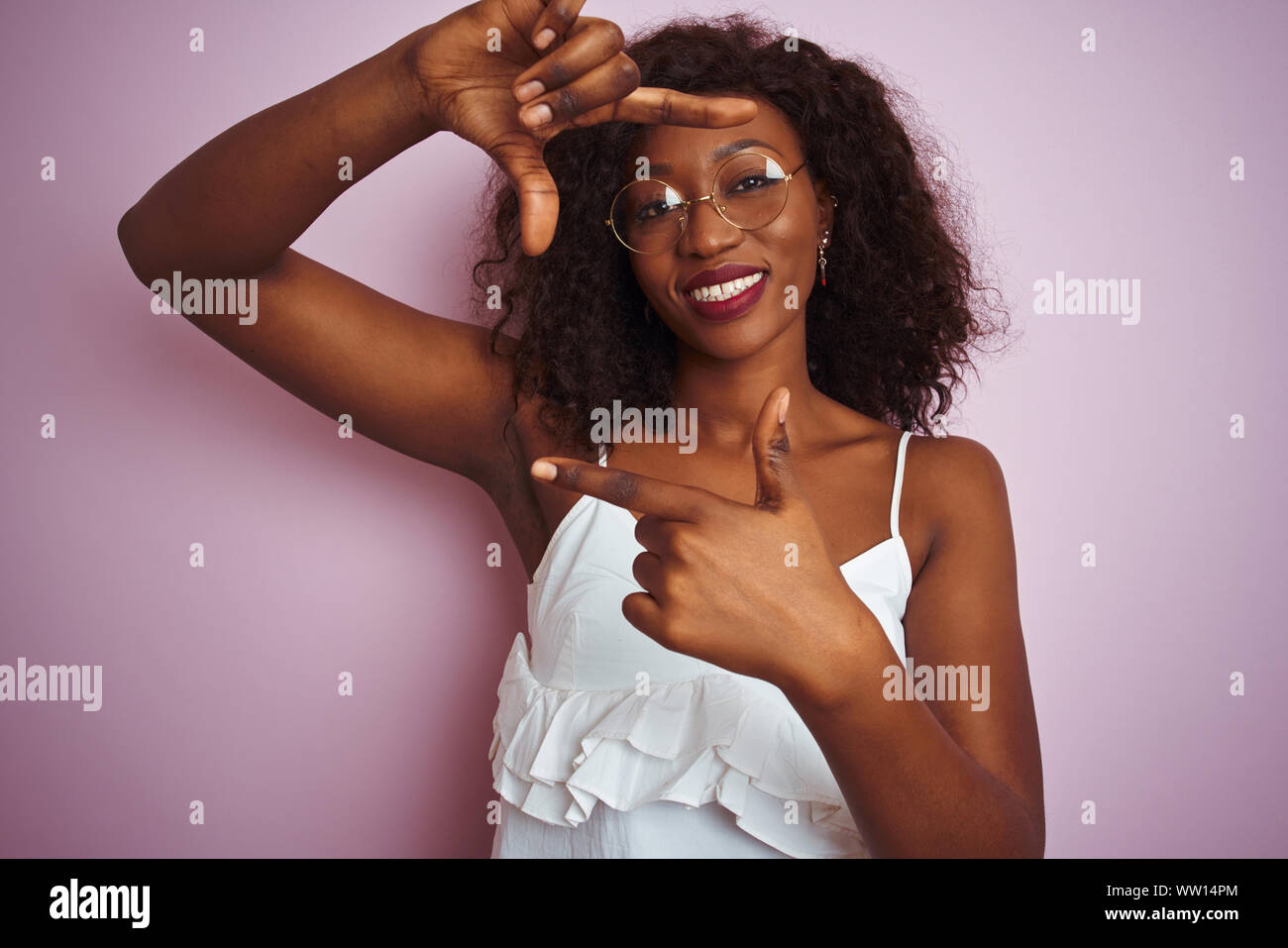 Young african american woman wearing glasses standing over isolated ...