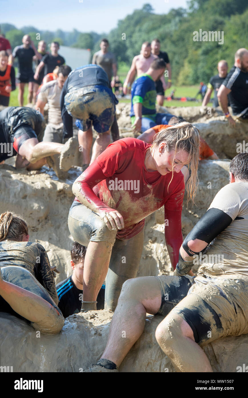 Contestants on the ‘Mud Mile’ at the Tough Mudder endurance event in Badminton Park, Gloucestershire UK Stock Photo