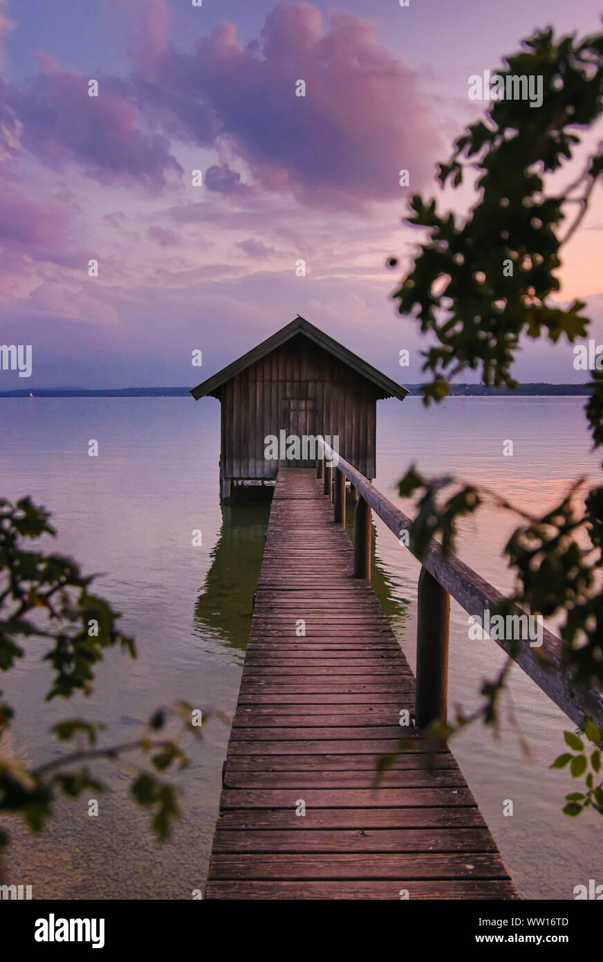 peaceful violet sunset with boat house at lake Ammersee Stock Photo
