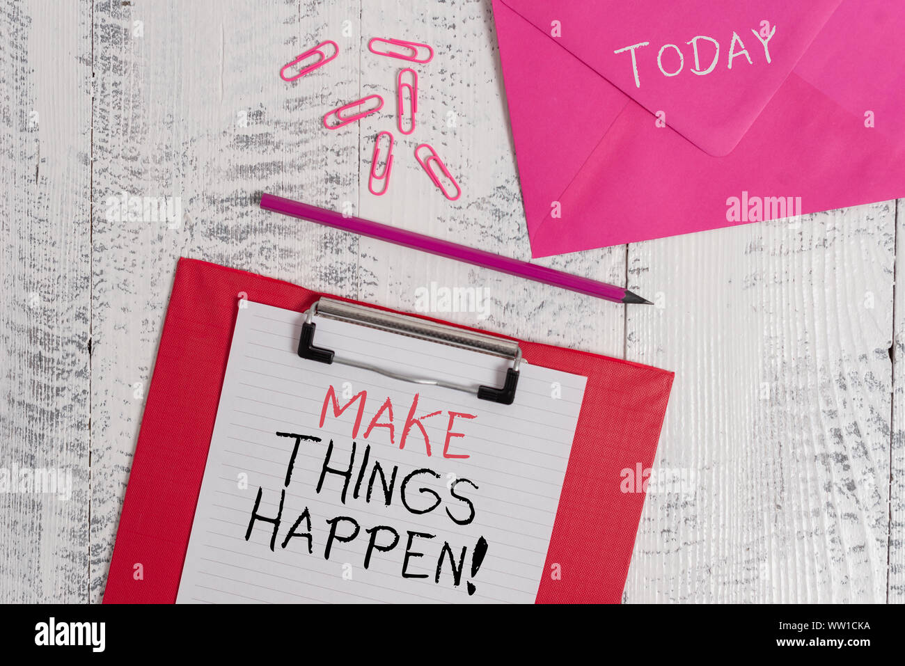 Conceptual hand writing showing Make Things Happen. Concept meaning you will have to make hard efforts in order to achieve it Colored clipboard paper Stock Photo