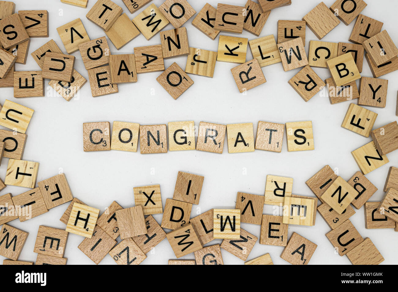 Congratulations message spelt in scrabble letters surrounded by various tiles Stock Photo