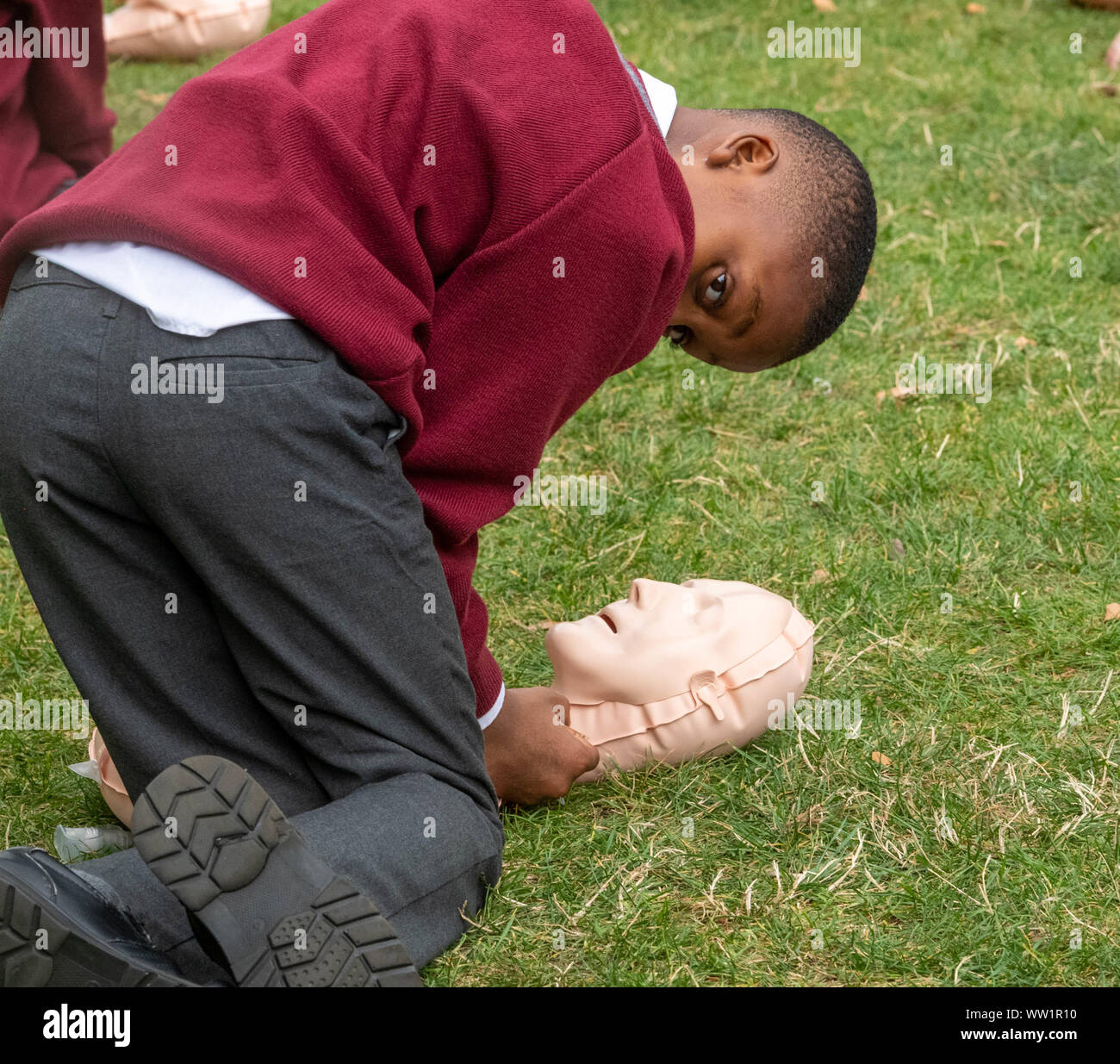 London UK, 12th September 2019 The British Red Cross hosts a demonstration of 100 school children conducting first aid outside the Houses of Parliament to mark the achievement of getting first aid on the school curriculum pictured boy working on a resuscitation  doll  Credit Ian DavidsonAlamy Live News Stock Photo