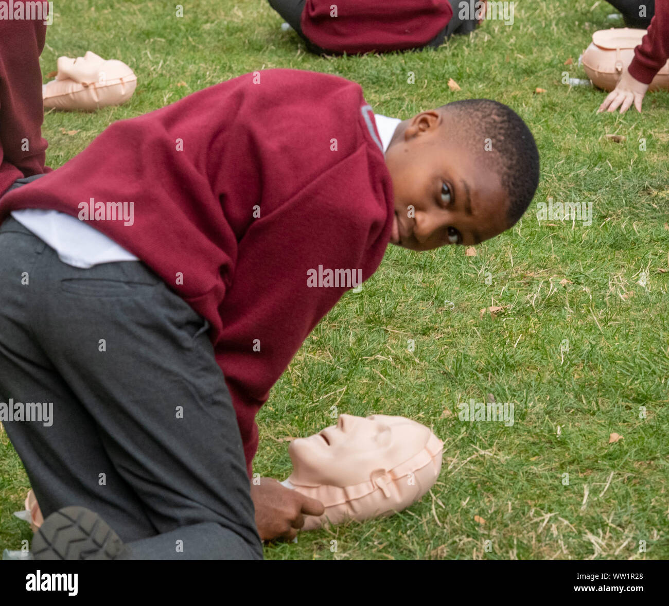 London UK, 12th September 2019 The British Red Cross hosts a demonstration of 100 school children conducting first aid outside the Houses of Parliament to mark the achievement of getting first aid on the school curriculum pictured boy working on a resuscitation  doll  Credit Ian DavidsonAlamy Live News Stock Photo