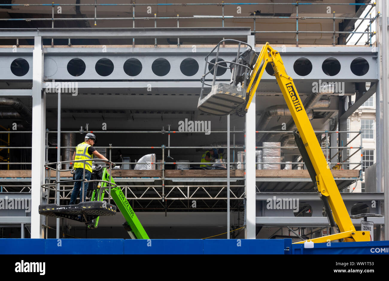 Worker operating a Facelift cherry picker at a building site in Liverpool Stock Photo