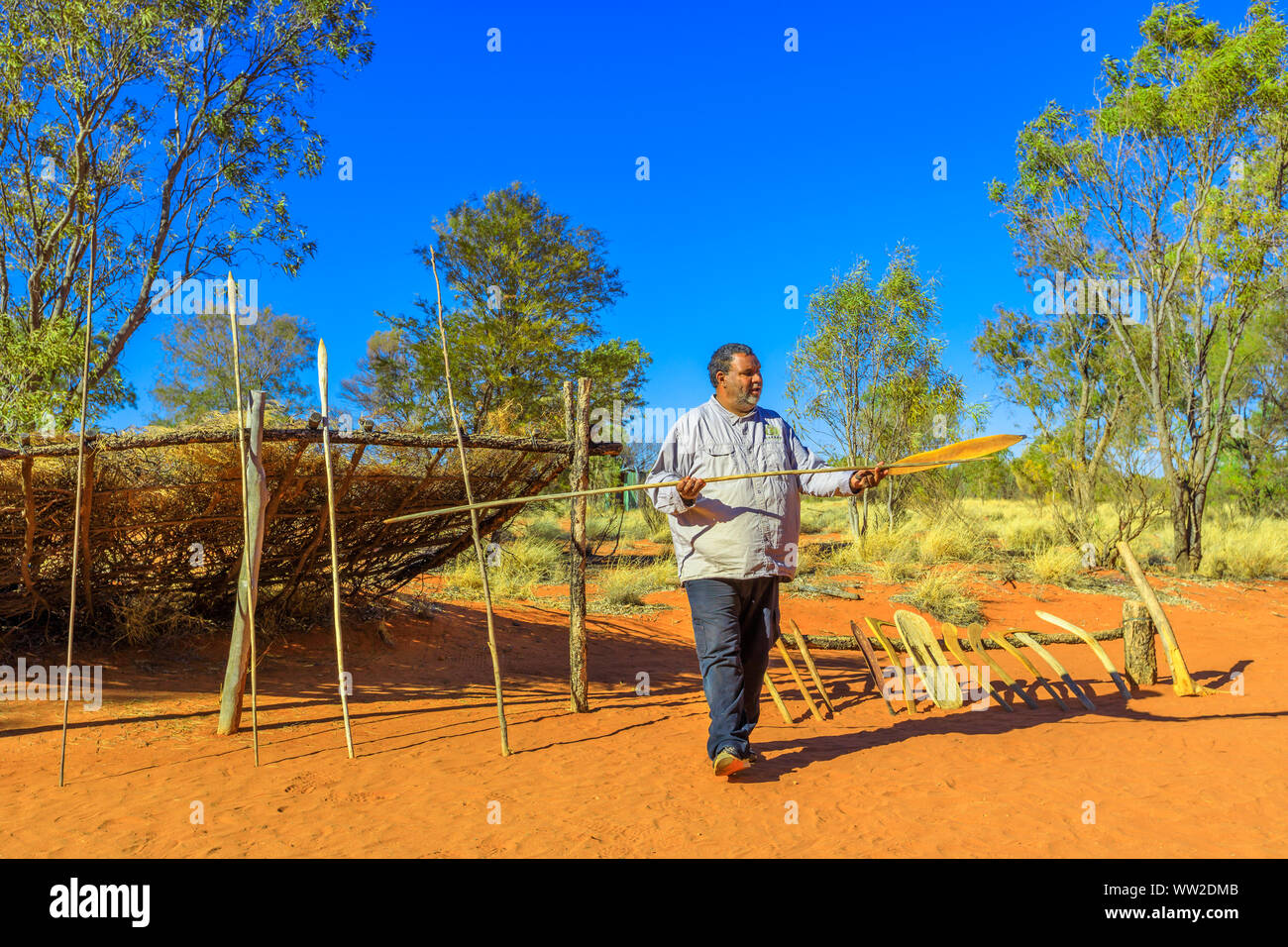 Kings Creek Station, Northern Territory, Australia - Aug 21, 2019: aboriginal Australian man shows a wooden spear and typical hunting weapons used by Stock Photo