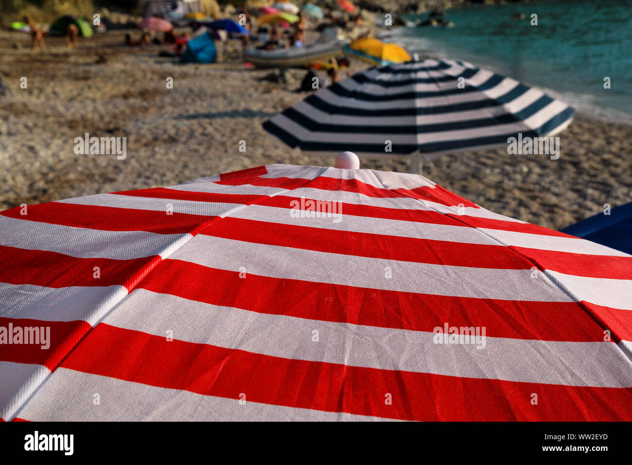 Red, blue and white sun umbrella for sunbathing and protection of sun