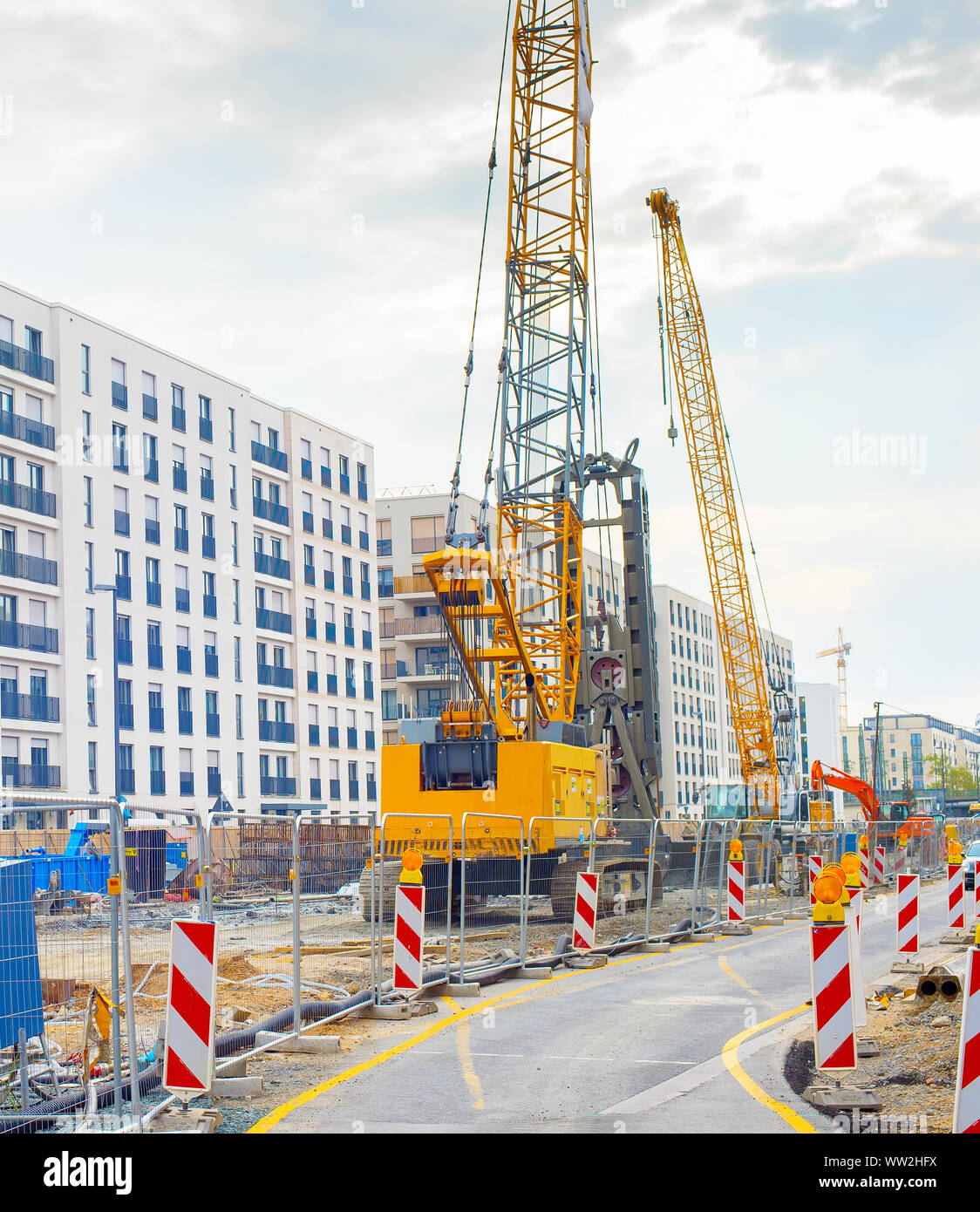 Excavator, cranes and construction equipment at construction site in