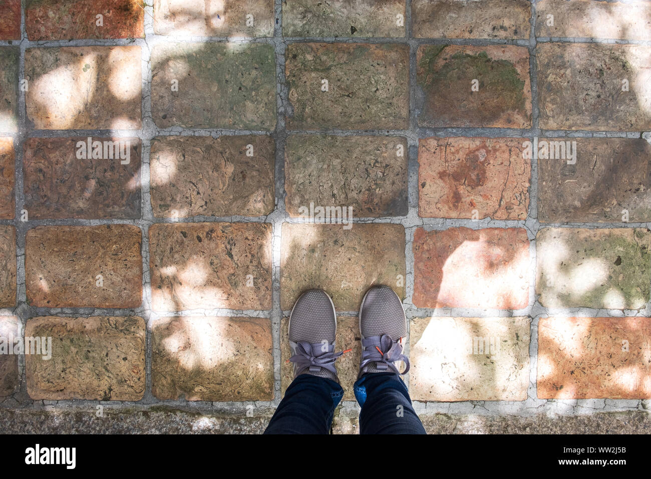 Top View Of Grey Sneakers Standing On Concrete Floor With Copy