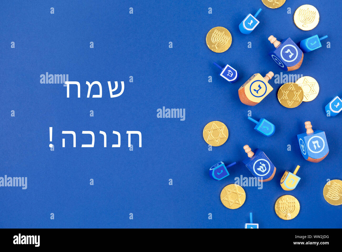 Dark blue background with dreidels and chocolate coins and Happy ...
