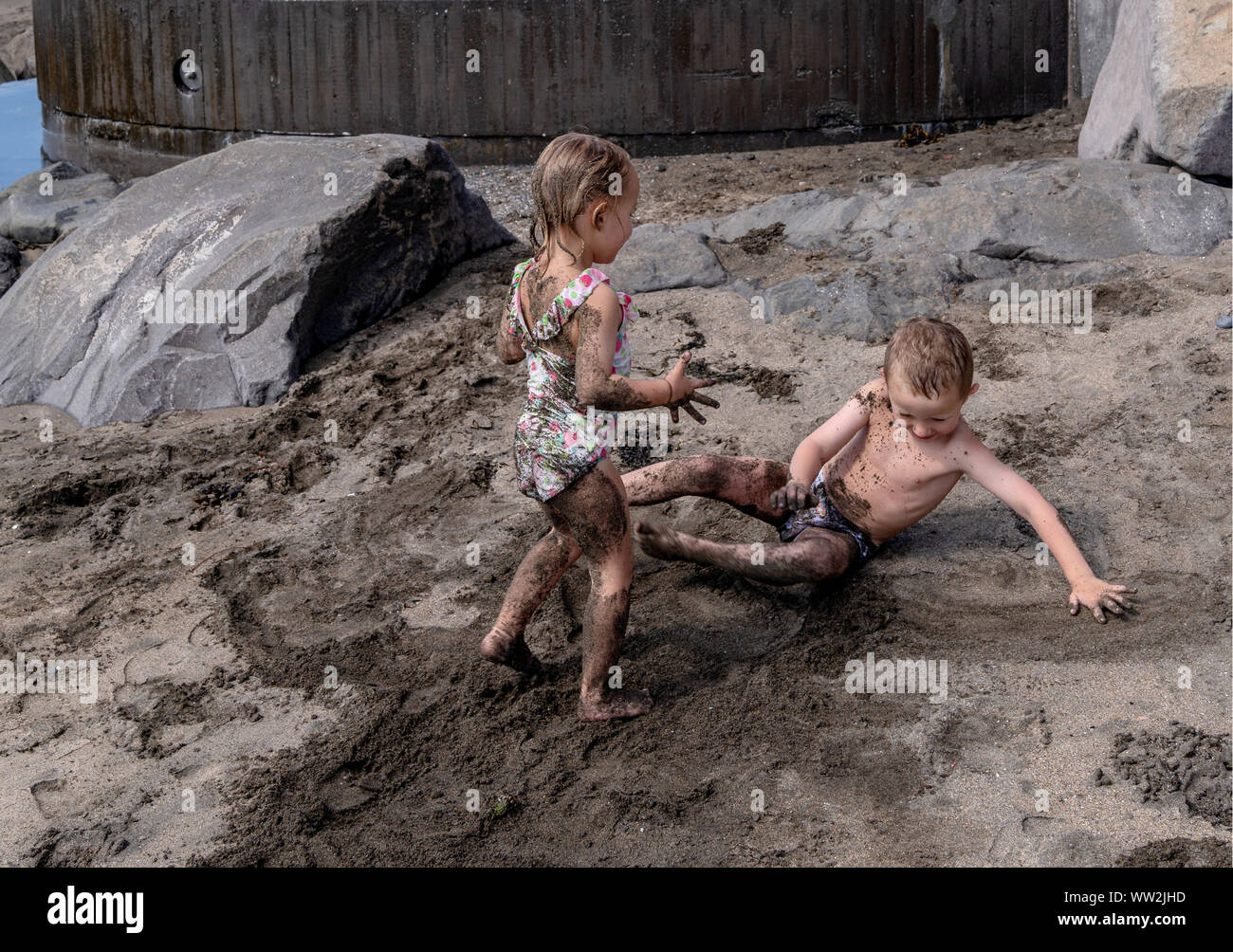 Kids playing in the sand at the beach, Akranes, Iceland Stock Photo