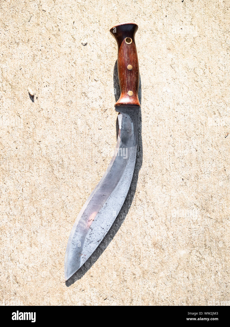 top view of Khukuri traditional Nepali knife on outdoor concrete board Stock Photo