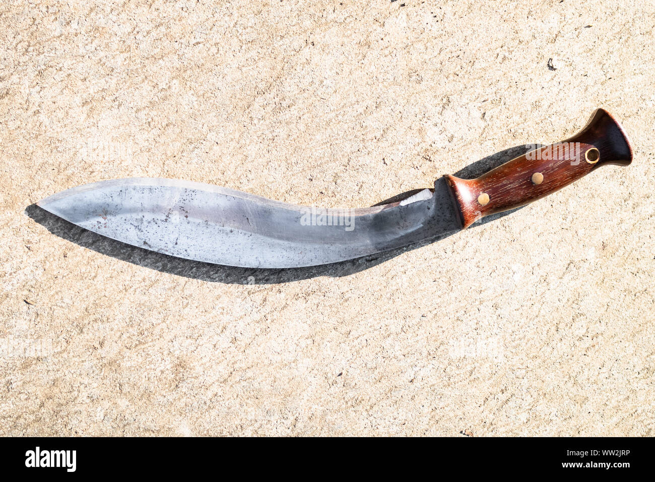 top view of traditional Nepali knife Kukri on outdoor concrete board Stock Photo