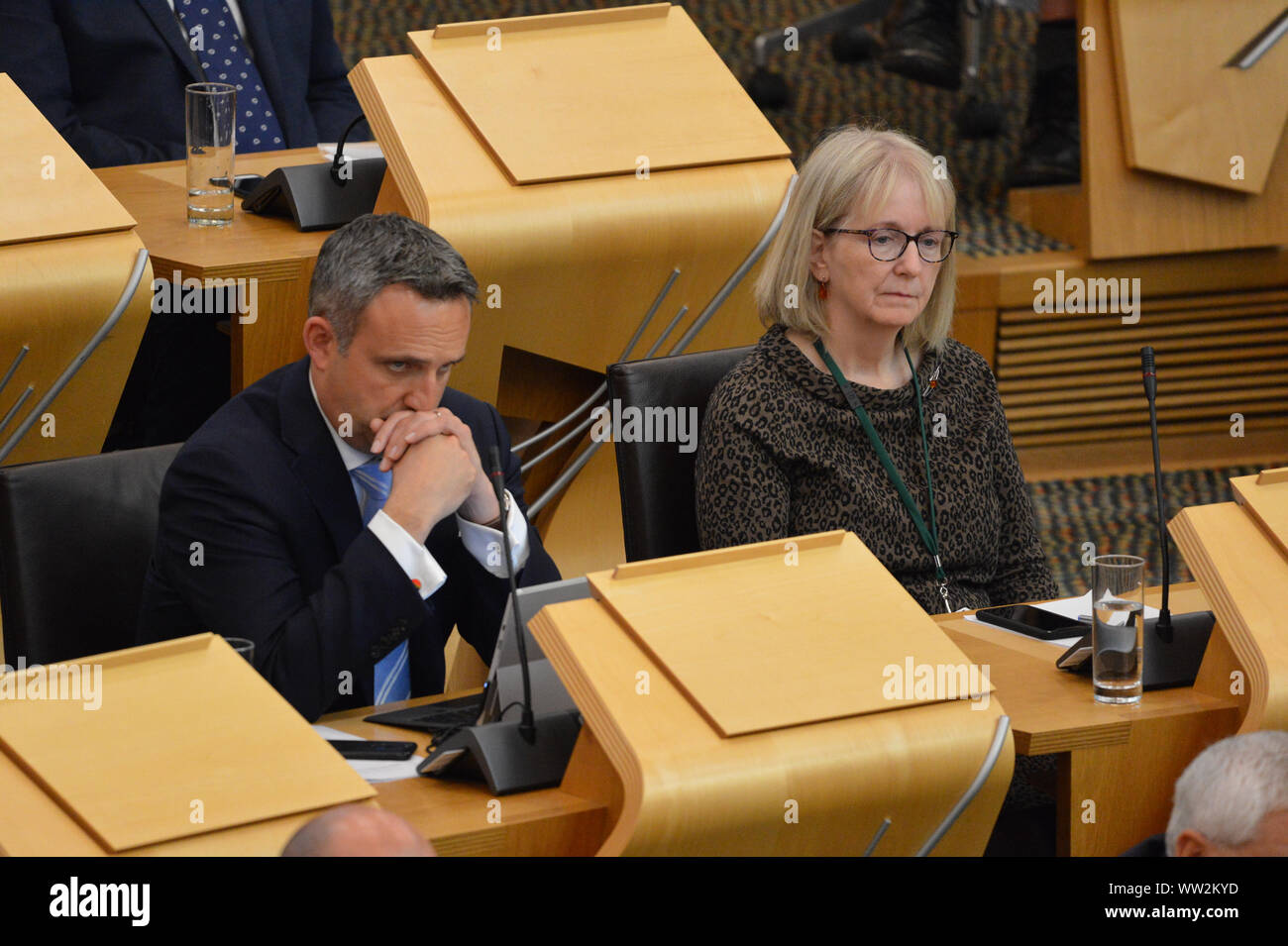 Edinburgh, UK. 12th Sep, 2019. Pictured: (left-right) Alex Cole-Hamilton MSP; Beatrice Wishart MSP. First session of First Ministers Questions as the Scottish Parliament tries to steer a path through the fallout of the latest Brexit mess and prevent Scotland from leaving the EU. Credit: Colin Fisher/Alamy Live News Stock Photo