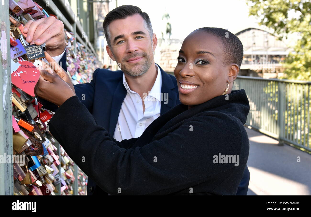 Cologne, Germany. 12th Sep, 2019. The actor Jo Weil and the singer Aisata Blackman install a love castle on the Hohenzollern Bridge in Cologne. Both play the leading role in the musical Bodyguard, which will also be guest in the musical Dome Köln from 23.10.2019. Credit: Horst Galuschka/dpa/Horst Galuschka dpa/Alamy Live News Stock Photo