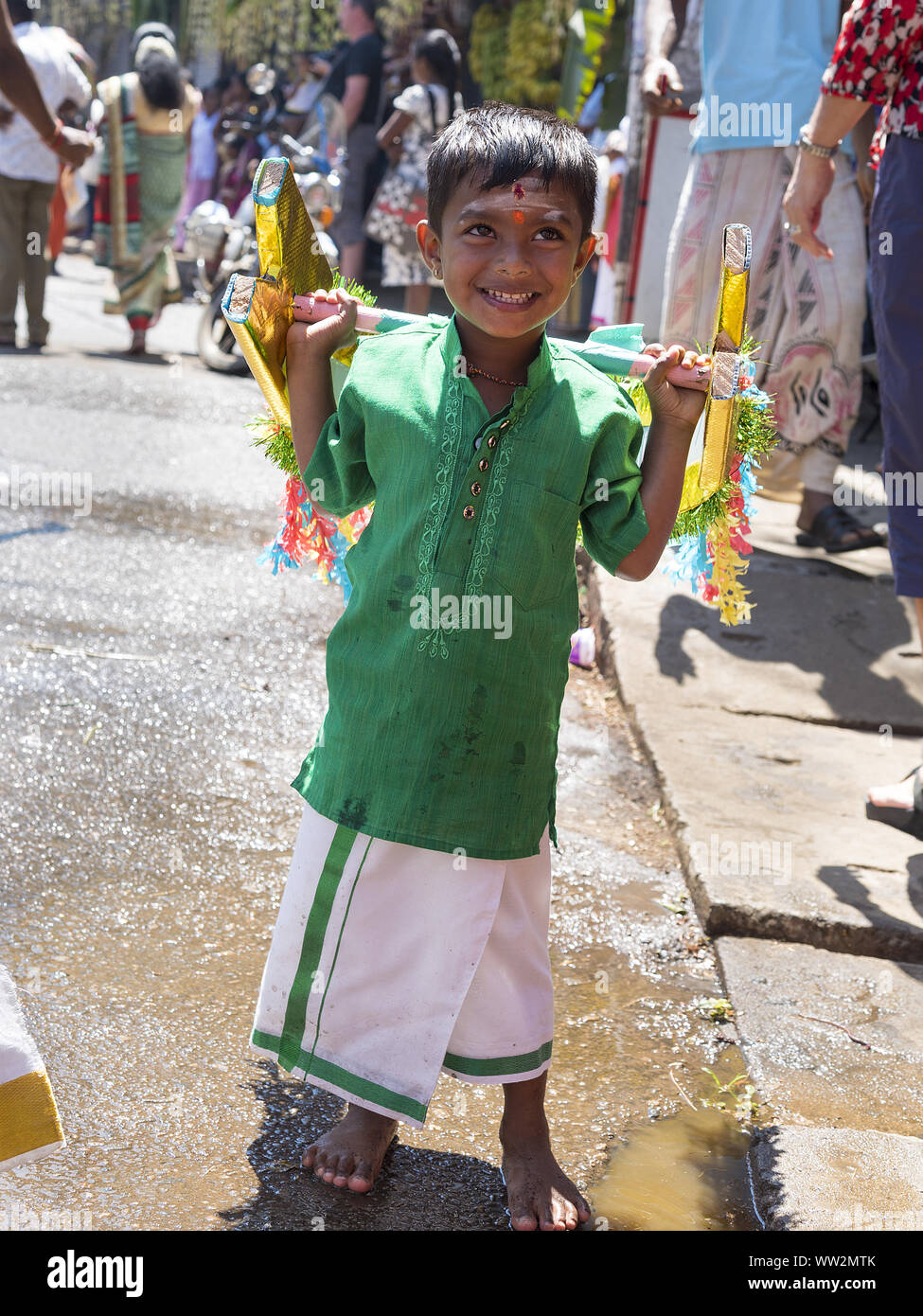 Pussellawa, Sri Lanka,  03/20/2019: Hindu festival of Thaipusam - body piercing rituals under the blood moon. Boy with shoulder weights. Stock Photo