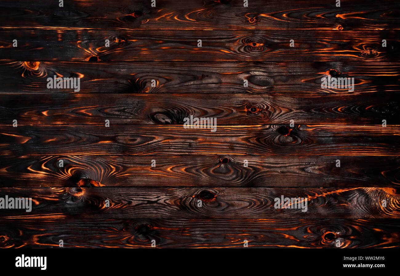 Burnt wooden board, black charcoal wood texture, burned barbecue background Stock Photo