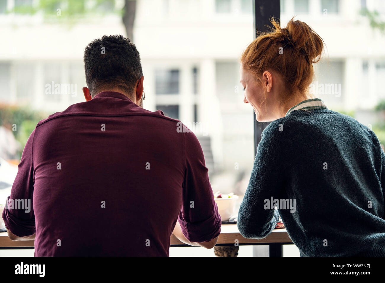 Woman sitting man rear table hi-res stock photography and images - Alamy