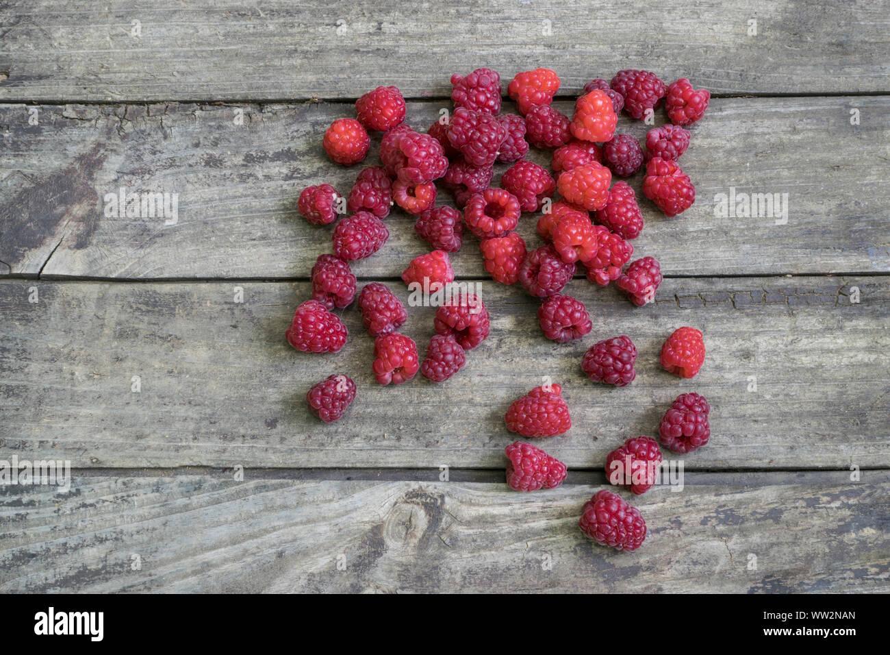 Fresh raspberries on old , rustic, wooden table. Stock Photo