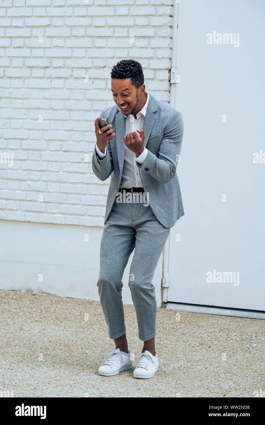 Man using smartphone outdoors Stock Photo
