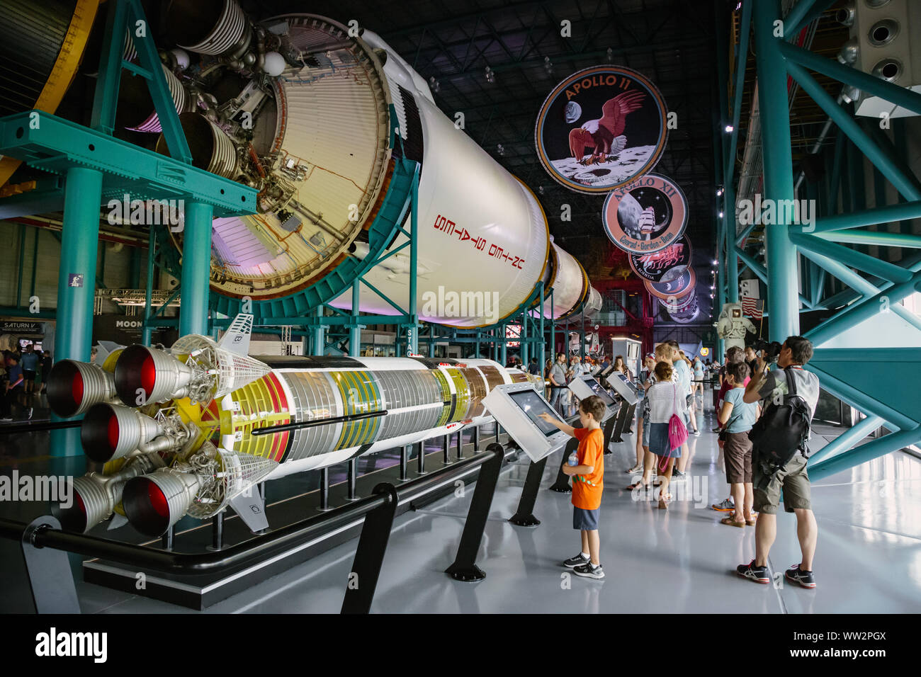 Visitors viewing the Apollo Saturn V rocket exhibit. Kennedy Space centre, Florida. Stock Photo