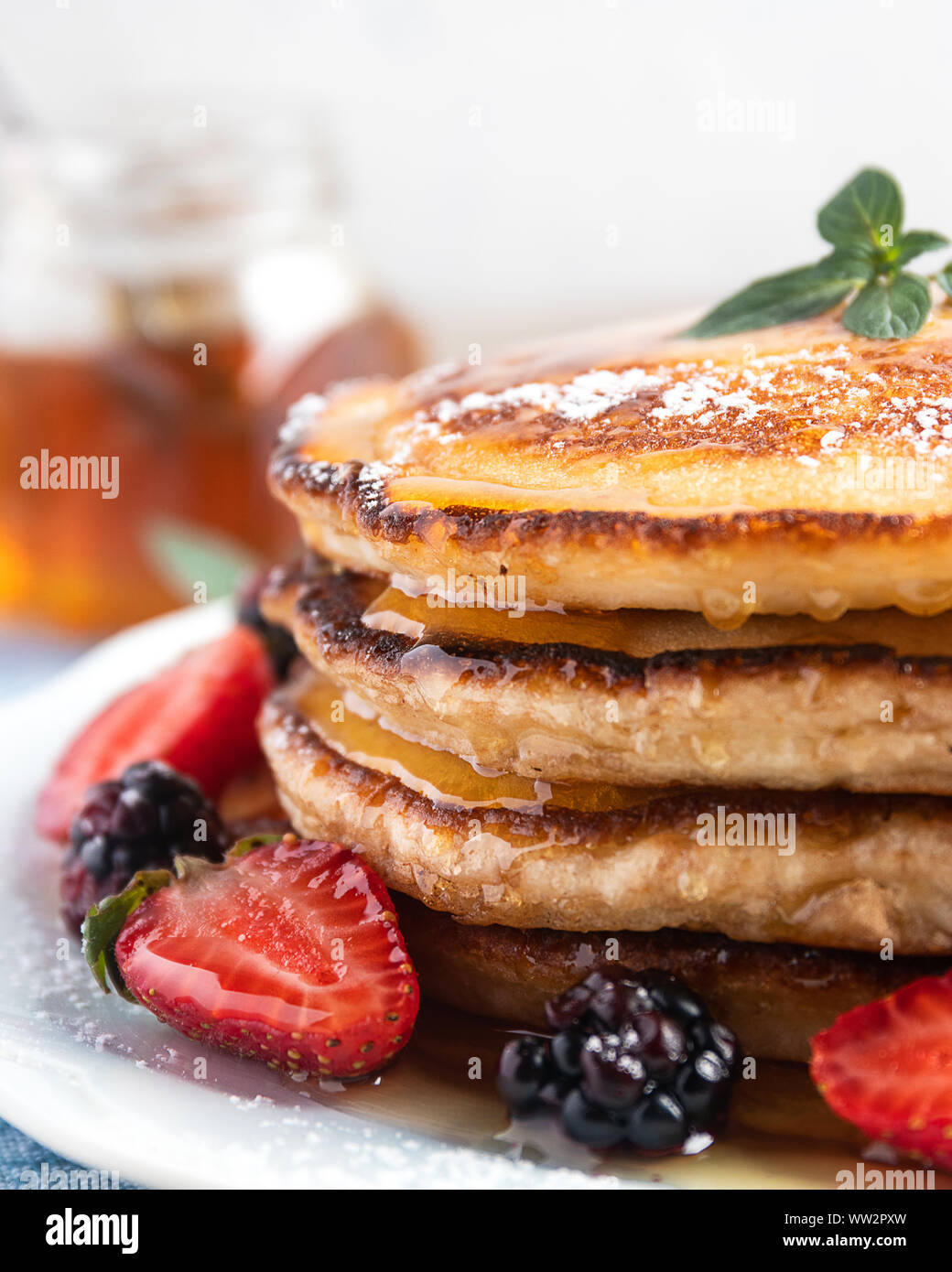 Tasty traditional russian breakfast of pancakes with honey on plate. Rustic  style. Stock Photo by ©Svetlana_Cherruty 151382336