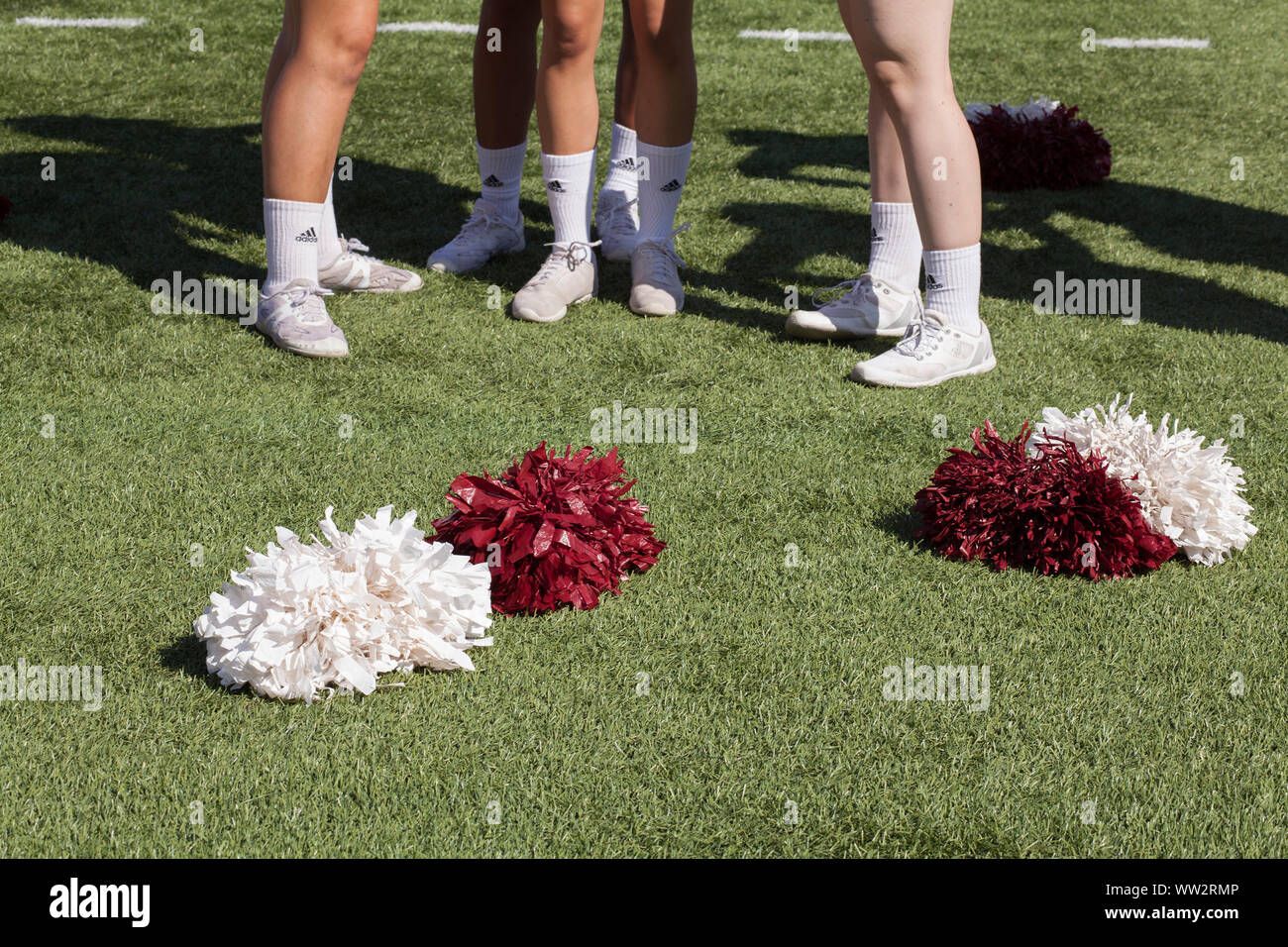 Kegs and feet of cheerleaders at University of Massachusetts  playing at home game in Amherst, MA Stock Photo