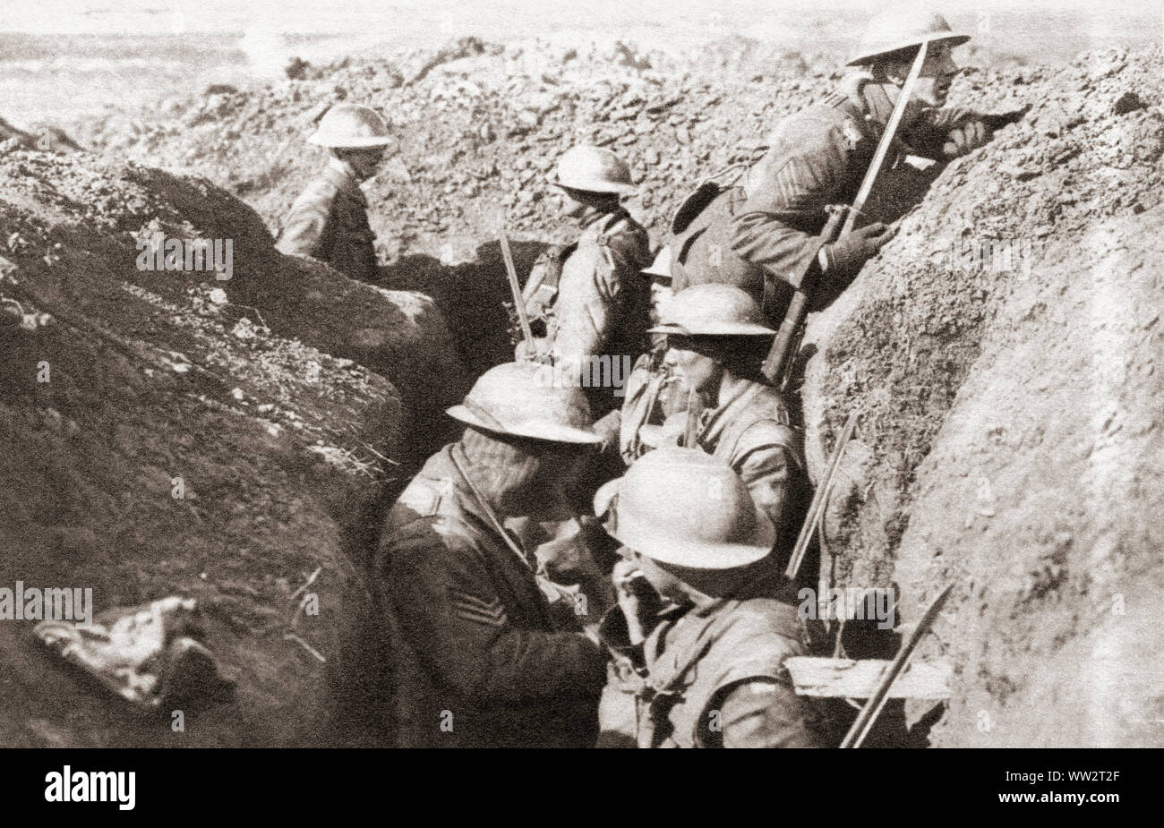 Tin-hatted British troops in the front line opposite St. Quentin during the advance in 1917 to the Hindenburg line on the Western Front during WWI.   From The Pageant of the Century, published 1934. Stock Photo