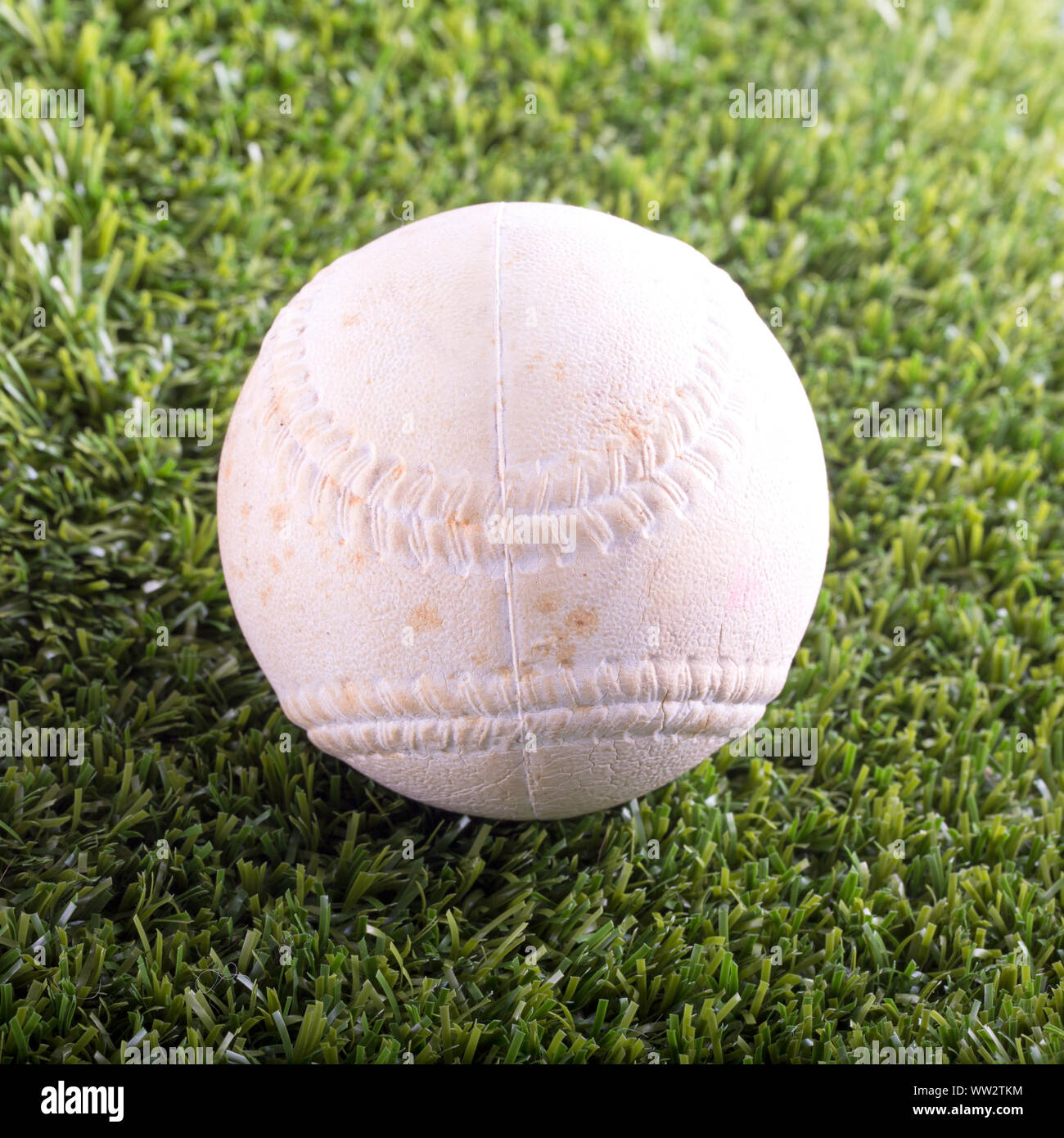 White baseball over synthetic grass, square image Stock Photo