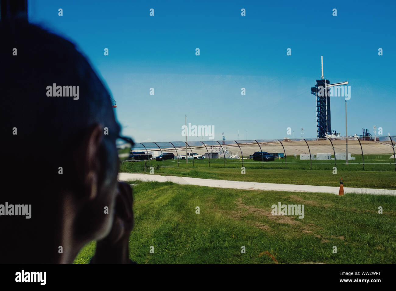 Man looking out at NASA Kennedy Space Center launchpad from tour bus. Florida, USA Stock Photo