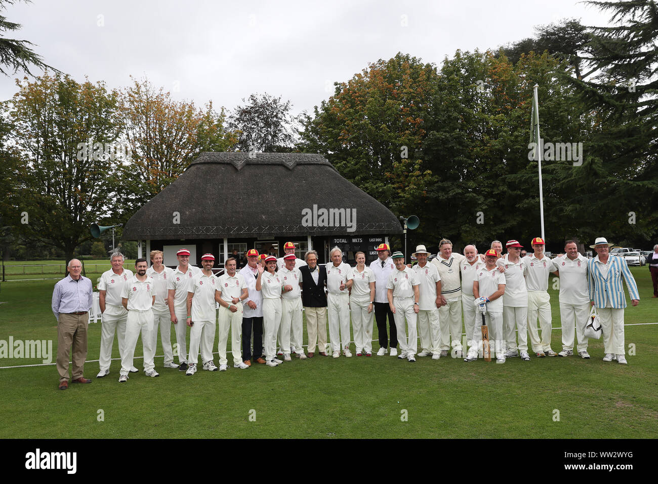 Goodwood, West Sussex, UK. 12th September 2019. The Goodwood Revival cricket matchs teams pose for a photo with the Duke of Richmond & Gordon. The teams include many famous drivers such as Derek Bell, Brendon Hartley, Stuart Graham and are called the Duke of Richmond & Gordon's XI and the Earl of March & Kinrara's XI at the Goodwood Revival in Goodwood, West Sussex, UK. © Malcolm Greig/Alamy Live News Stock Photo