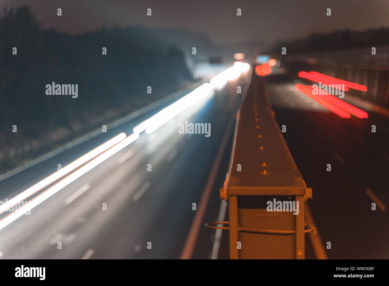A4 Highway in Germany Chemnitz. Long time exposure of traffic on the move with close up of metal that seperates left and right with copy space Stock Photo