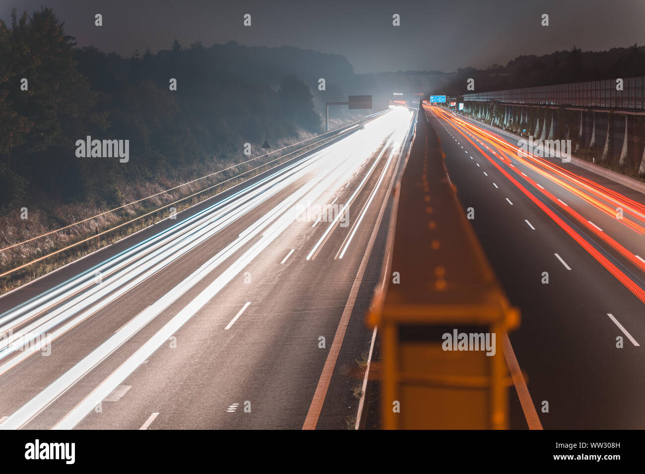 A4 Highway in Germany Chemnitz. Long time exposure of traffic on the move with close up of metal that seperates left and right with copy space Stock Photo