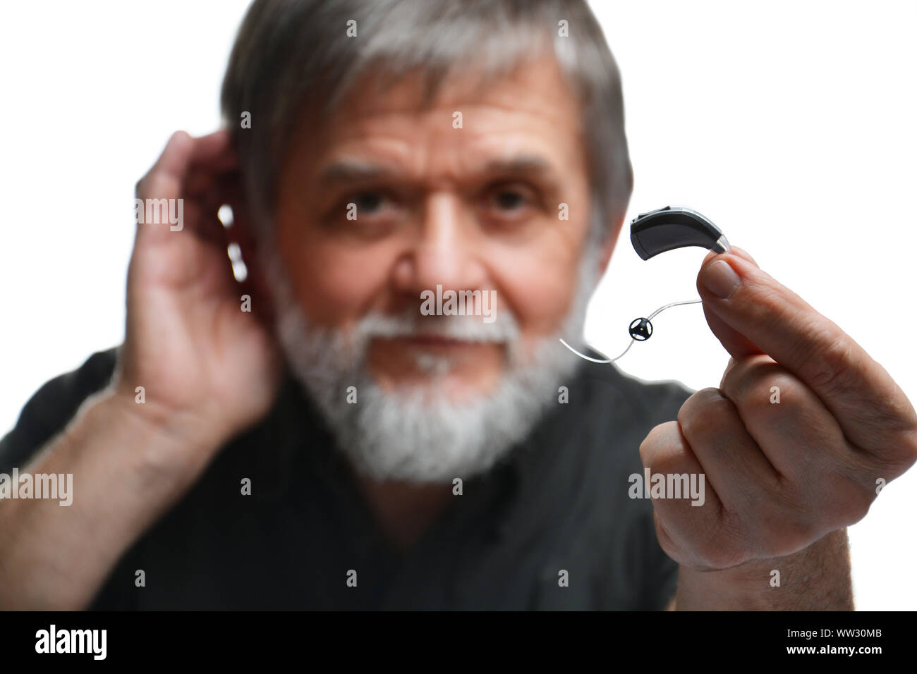 Old man shows hearing aid Stock Photo